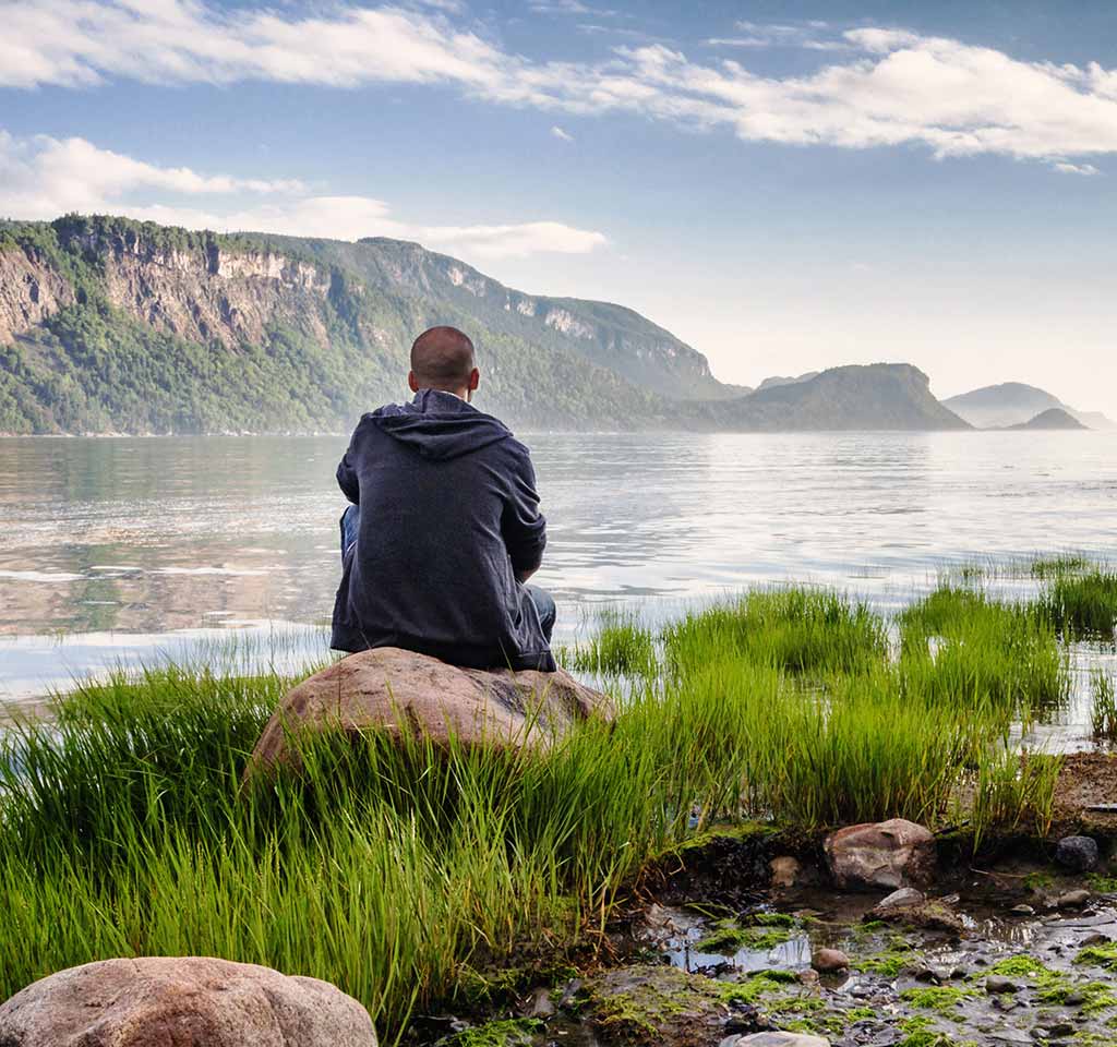 Young Man Looking Out At Ocean